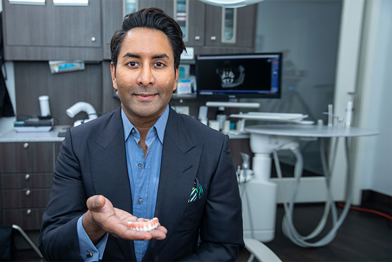 Dr. Palani holding zirconia bridge